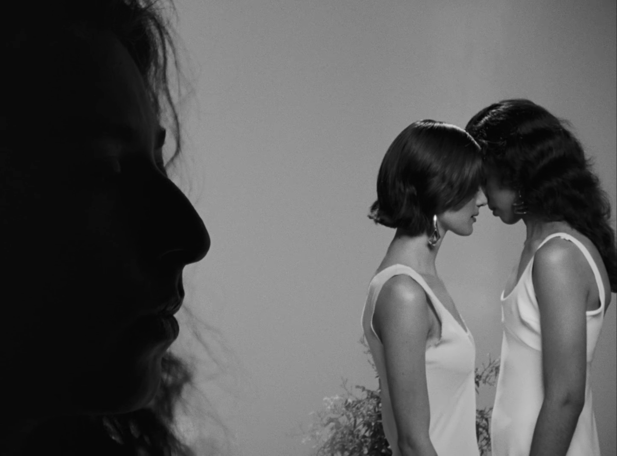 two women about to kiss in the Raat Ki Rani music video in black and white